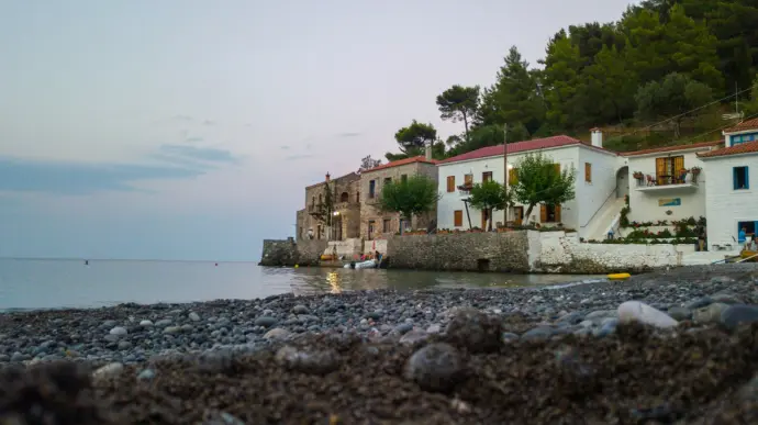 white and brown concrete building near body of water during daytime