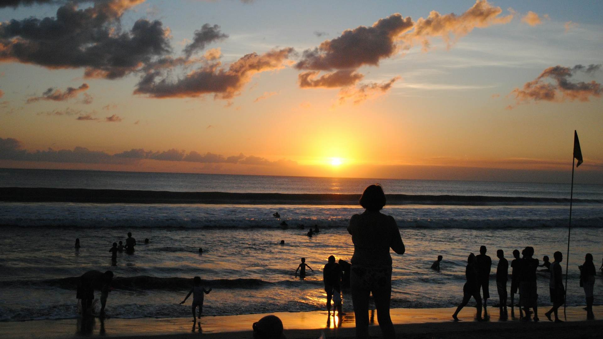 silhouette of people on beach during sunset