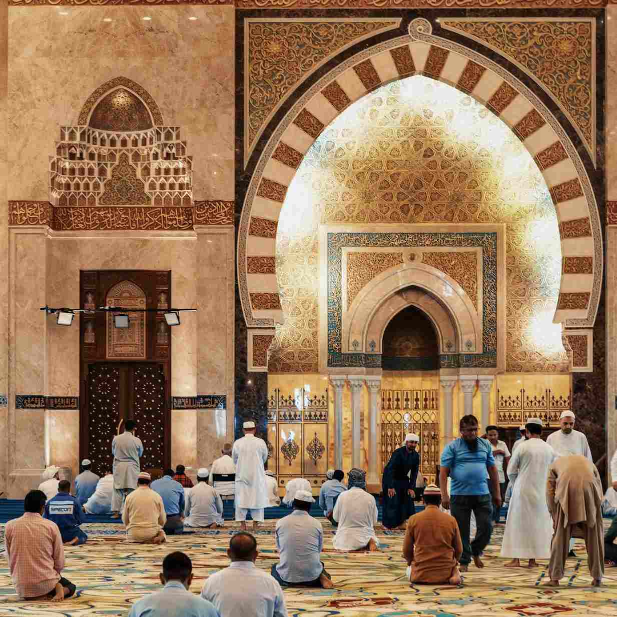 men kneeling and bowing inside building